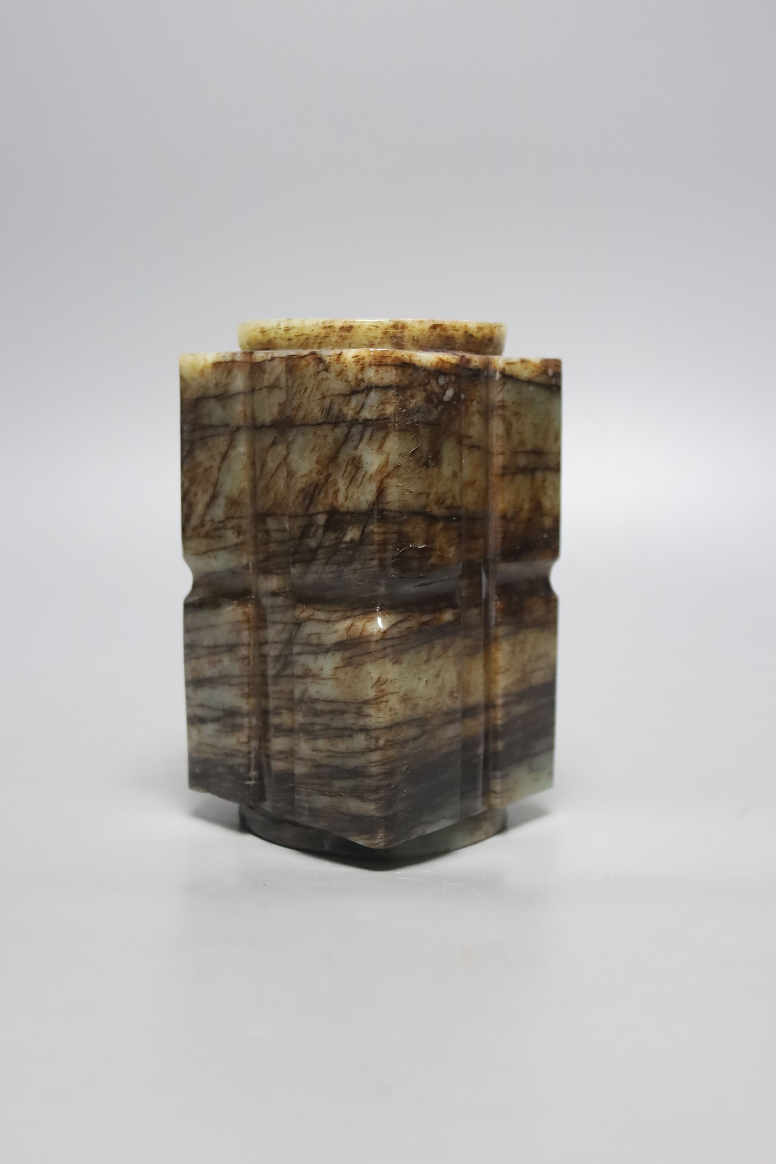 A Chinese pale celadon and black jade cong, H. 14cm